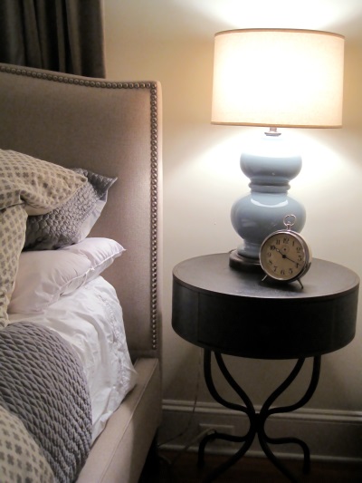 Comfy bedding and a warmly glowing bedside lamp makes guests feel welcome here!